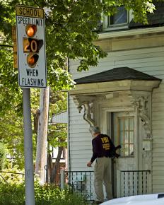 An FBI agent knocks on the door of a family's home